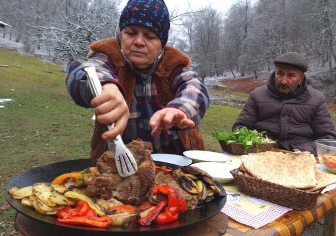 T-bone Steak with Vegetables Cooking on the Sadj